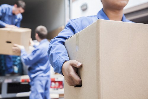 Movers preparing items safely with protective equipment and careful handling
