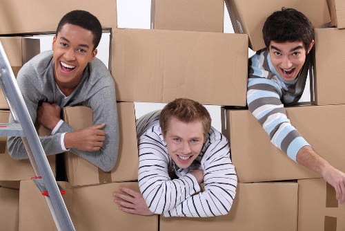 Movers carrying household items from a flat in Haringey with careful access planning