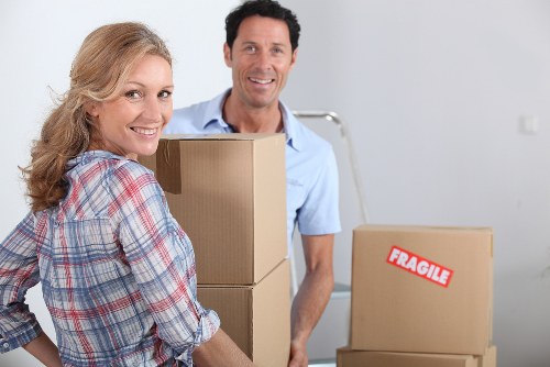 Mover carrying household items during a relocation service